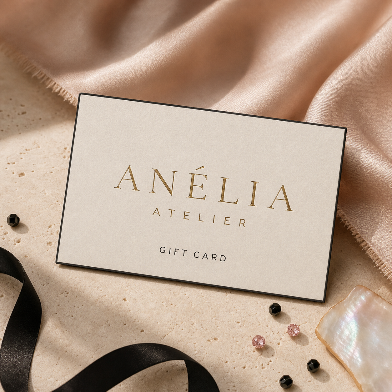 Anelia Atelier gift card on blush silk and warm ivory stone